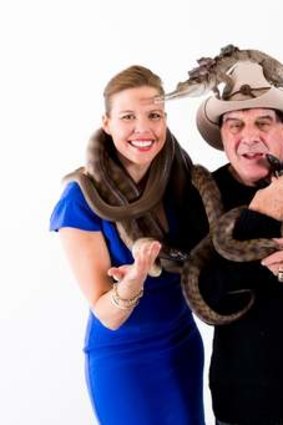 Nicole Rose gets her skin close to two snakes and Molly Meldrum.