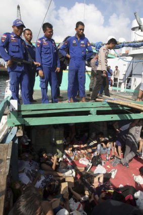 Indonesian marine police officers guard the asylum seekers.