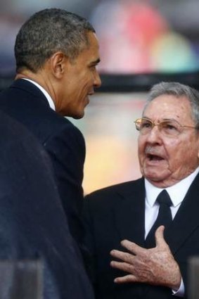 Differences set aside ... US President Barack Obama greets Cuban President Raul Castro before giving his speech, as Brazil's President Dilma Rousseff looks on at the memorial service for Nelson Mandela.