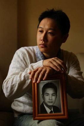 Languing in jail ... Tommy Du holds a photo of his father, Du Zuying.