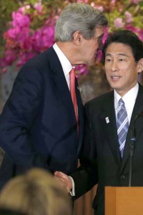 Got your back: US Secretary of State John Kerry shakes hands with Japanese Foreign Minister Fumio Kishida.