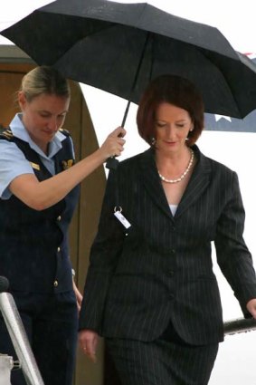 Julia Gillard: sheltering from the storm. <i>Photo: Ben Crabtree</i>