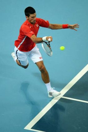Novak Djokovic returns service to Florian Mayer.