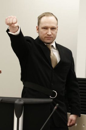 Anders Behring Breivik salutes as he enters the court on the first day of his trial.