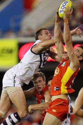 Charlie Dixon of the Suns marks over Jonathon Griffin of the Dockers.