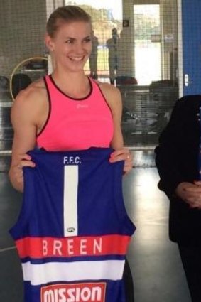 Australian sprint champion Melissa Breen gets presented with a jersey from Western Bulldogs vice-president Sue Alberti, who has donated money for Breen's training.