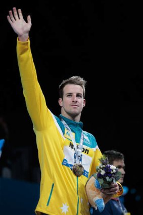 Back in front: James Magnussen celebrates on the podium after winning the 100 metres freestyle.