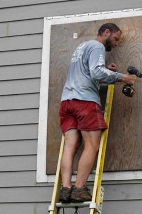 A man readies his North Carolina home.