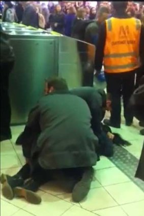 A girl is restrained at Flinders Street station.