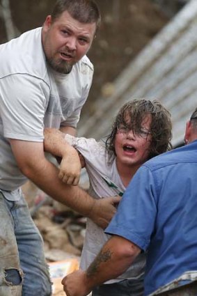 Anguish: A child calls to his father after being pulled from the rubble.