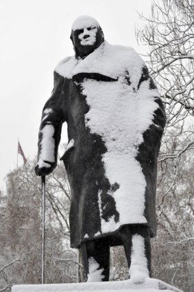 A statue of former British prime minister Winston Churchill is covered in snow in Parliament Square, London.