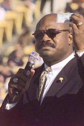 Chicago Bears player Dave Duerson holds up an organ donor card at a memorial service for a team mate. Duerson later  took his own life and donated his brain to science.