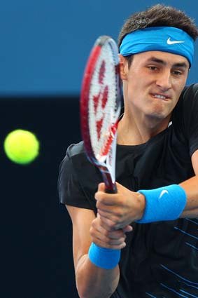 Bernard Tomic in action against Andy Murray.