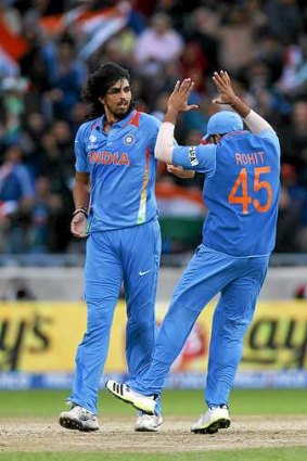 Start of the collapse: Ishant Sharma, left, celebrates with  Rohit Sharma after taking the wicket of Eoin Morgan.