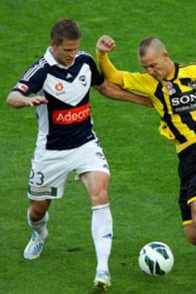 Stein Huysegems of the Phoenix attempts to evade the defence of Adrian Leijer (left) and Mark Milligan of the Victory.