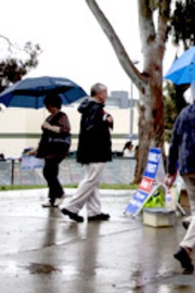 Voters battle the elements to cast their votes in Glen Waverley.