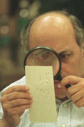 The infamous recount: A judge uses a magnifying glass to view a dimpled chad on a ballot in 2000 in Florida.
