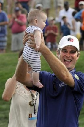 Kevin Streelman celebrates with his six-month old daughter, Sophia