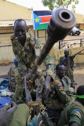 A South Sudanese soldier stands next to a truck-mounted machine gun in Malakal town, northeast of Juba.