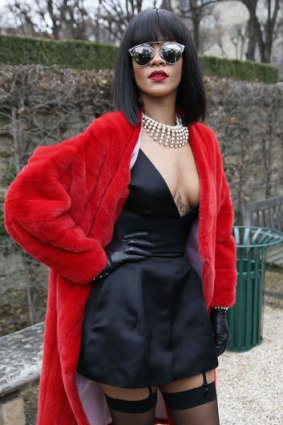 Barbadian singer Rihanna poses as she arrives to attend Christian Dior 2014/2015 Autumn/Winter ready-to-wear collection fashion show in Paris.