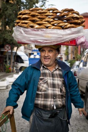 A vendor sells simit, a type of Turkish bread, in the streets of Istanbul.