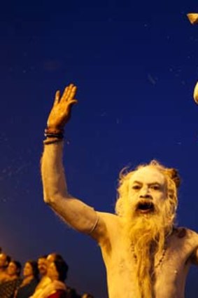 Now hear this: An Indian Naga Sadhu, or naked Hindu holy man, performs evening rituals after a holy dip at Sangam, the confluence of the Ganges, Yamuna and the Saraswati River, during the Maha Kumbh festival in Allahabad on Friday.
