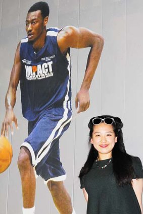 Yiying Lu next to one of her basketball graphics.