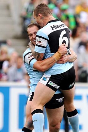 "It blows me away a bit to win six in a row" ... the Sharks' Todd Carney, right, celebrates with try-scorer Jeff Robson.