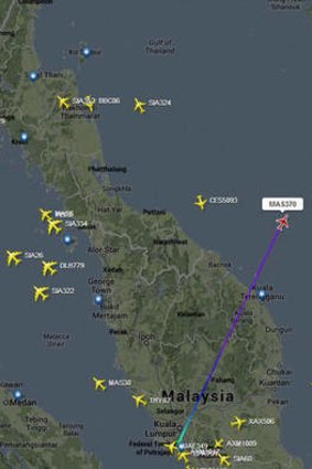 A flight tracker screenshot shows the point where MH370 went off radar.
