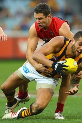 James Frawley, seen tackling Lance Franklin, is the Demons' latest injury worry.