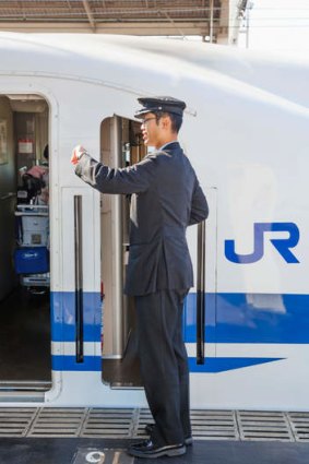 Always punctual ... a bullet train attendant on duty.