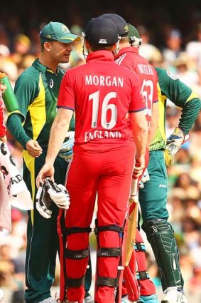 Stand-off: Michael Clarke has words with Eoin Morgan and Jos Buttler after Morgan stood his ground.