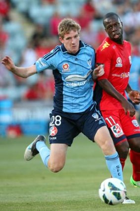 Pitched into deep end ... Sydney FC's Aaron Calver competes with Bruce Djite of Adelaide United.