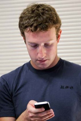 A Facebook phone, maybe ... Mark Zuckerberg  checks his mobile phone for messages.
