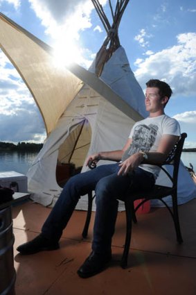 William Woodbridge maintains his tepee raft protest on Lake Ginninderra angered by housing affordability for students in Canberra.