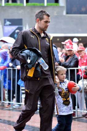 True leader: Luke Hodge with his son Cooper in yesterday's parade in the city.
