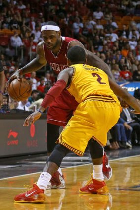 Cleveland's former fan favourite, LeBron James drives on Cavaliers guard Kyrie Irving.