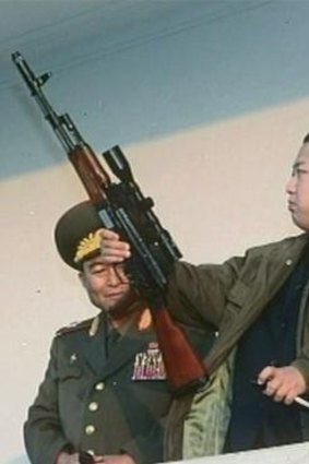 Kim Jong-un inspects an assault rifle.