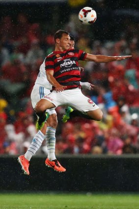 High hopes: Brendon Santalab of the Western Sydney Wanderers rises high to meet the ball.