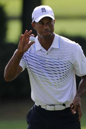 Tiger Woods reacts after a birdie on hole nine during the first round of the Tour Championship golf tournament in Atlanta, Georgia.