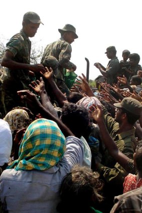 Aid station ... Sri Lankan soldiers distribute food to civilians said to have escaped from the Tamil Tiger-held area of the island nation.