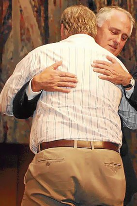 Malcolm Turnbull hugs Peter Hicks during his apology speech to the forgotten generation.