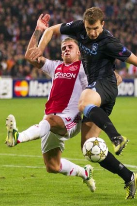 Ajax's Toby Alderweireld fights for the ball with Manchester City's Edin Dzeko.