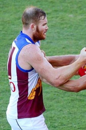 Daniel Merrett of the Lions and Jaeger O'Meara of the Giants get to grips with each other.