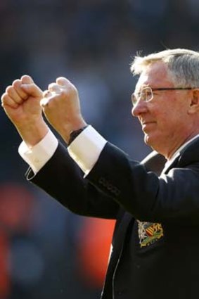 Manchester United manager Alex Ferguson salutes the fans.