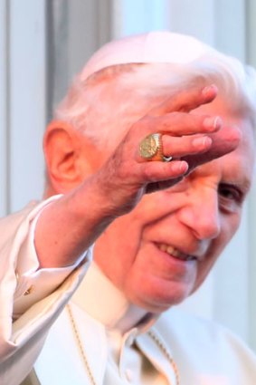 Pope Benedict XVI waves to pilgrims for the last time.