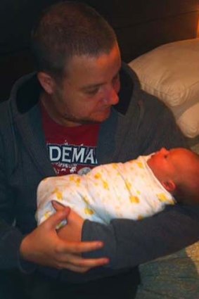 Matthew Blackmore, pictured here nursing his niece, is recovering in hospital after being king hit on George Street in Sydney's CBD.