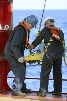 Crew on the Ocean Shield deploy the towed pinger locator.