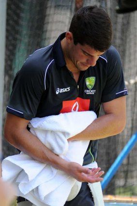Moises Henriques looks at his injured right hand during a Gabba training session.