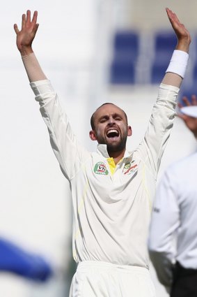 Nathan Lyon of Australia celebrates after taking the wicket of Ahmed Shehzad.